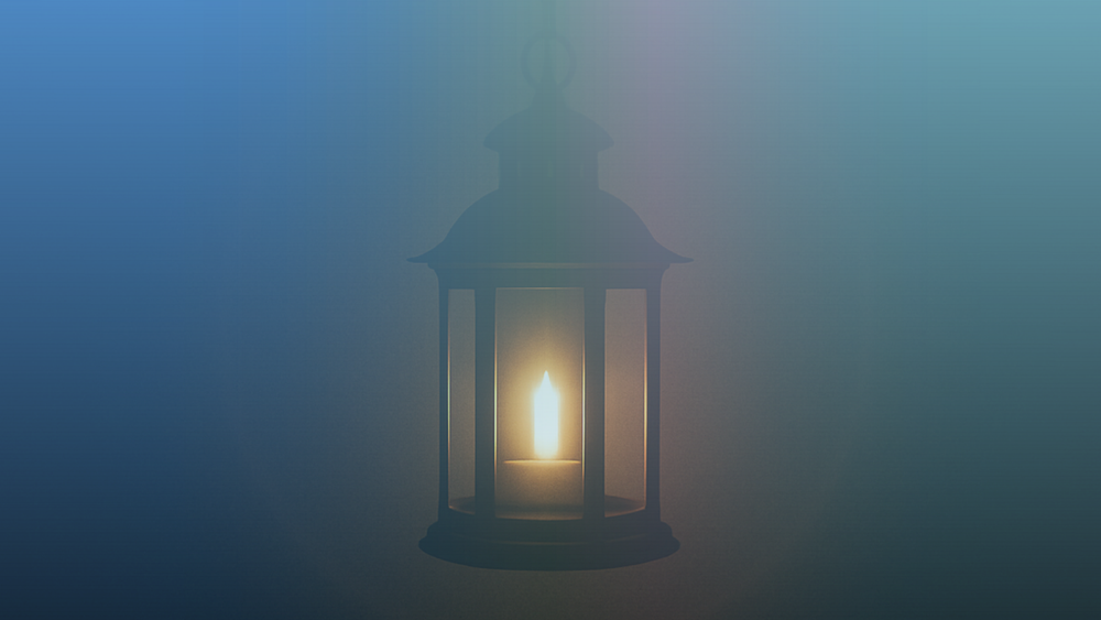 A single lantern glowing with candlelight in the dark